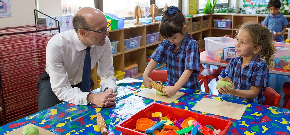 Dr Simon Watson interacting with two pupils